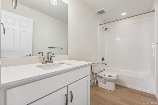 full bathroom with wood-type flooring, bathtub / shower combination, vanity, and toilet