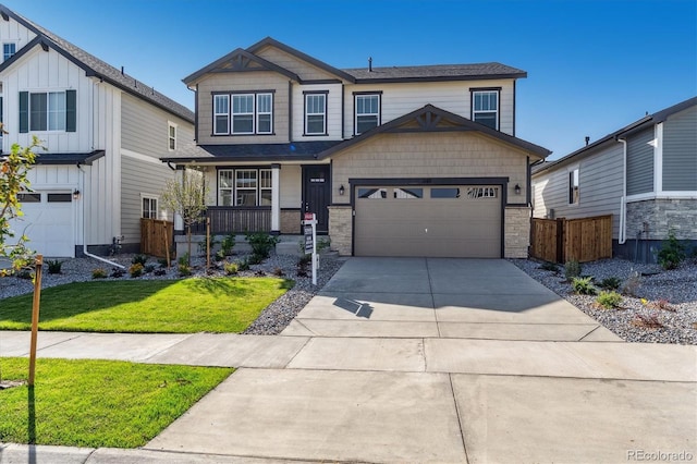 craftsman-style house with a garage, a front yard, and covered porch