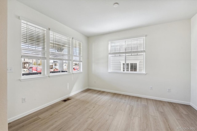 spare room featuring light wood-type flooring