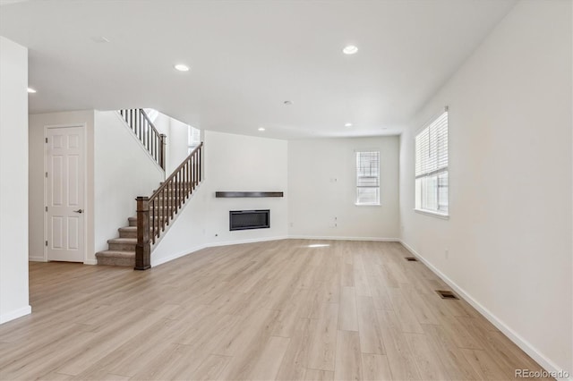 unfurnished living room featuring light hardwood / wood-style floors