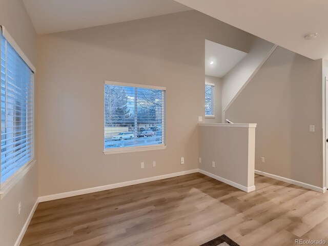 interior space with baseboards and wood finished floors