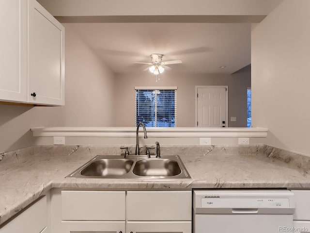 kitchen with white cabinets, a ceiling fan, dishwasher, light countertops, and a sink