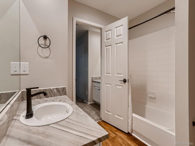 bathroom featuring shower / bathing tub combination, wood finished floors, and vanity