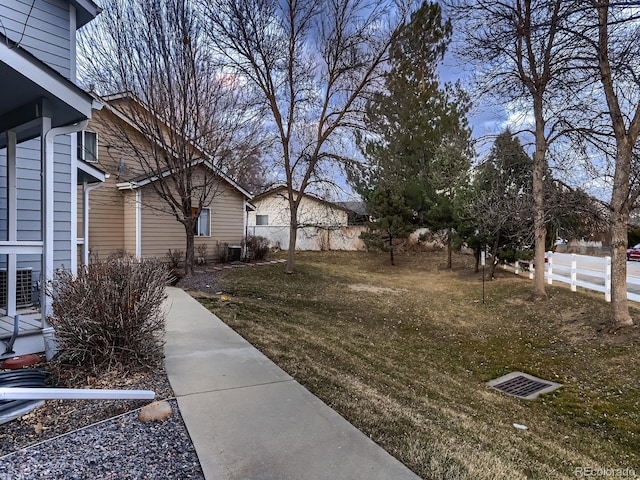 view of yard with fence and central AC