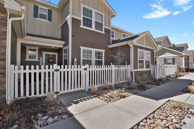 8765 Laurel Mountain Vw, Colorado Springs, CO 80924 - view of home's exterior featuring board and batten siding, a fenced front yard, and a gate