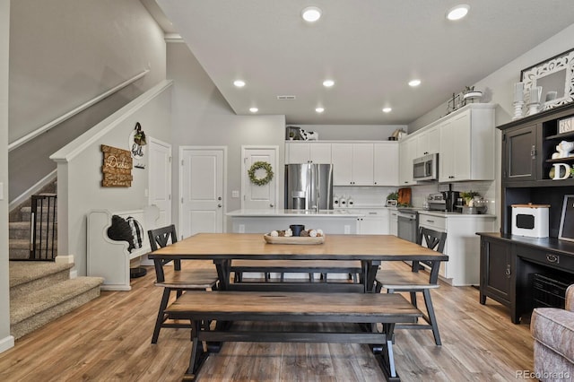 8765 Laurel Mountain Vw, Colorado Springs, CO 80924 - dining area with stairway, light wood-style flooring, and recessed lighting