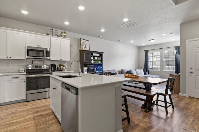8765 Laurel Mountain Vw, Colorado Springs, CO 80924 - kitchen featuring appliances with stainless steel finishes, light wood-type flooring, light countertops, and recessed lighting