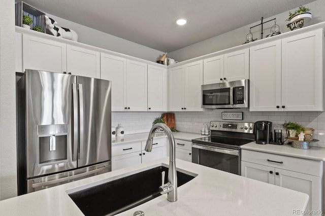 8765 Laurel Mountain Vw, Colorado Springs, CO 80924 - kitchen featuring appliances with stainless steel finishes, light countertops, white cabinets, and recessed lighting