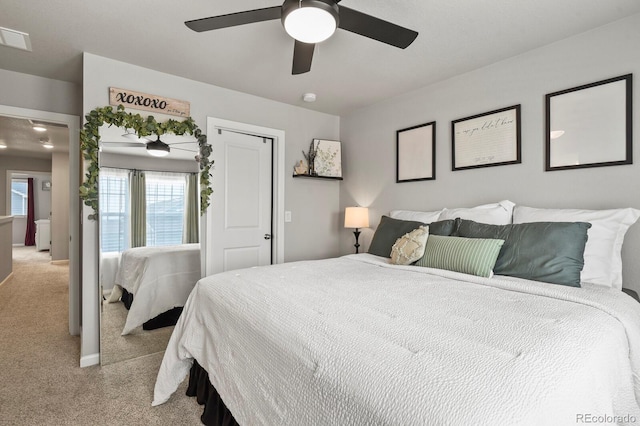 8765 Laurel Mountain Vw, Colorado Springs, CO 80924 - bedroom with light colored carpet, multiple windows, and a ceiling fan
