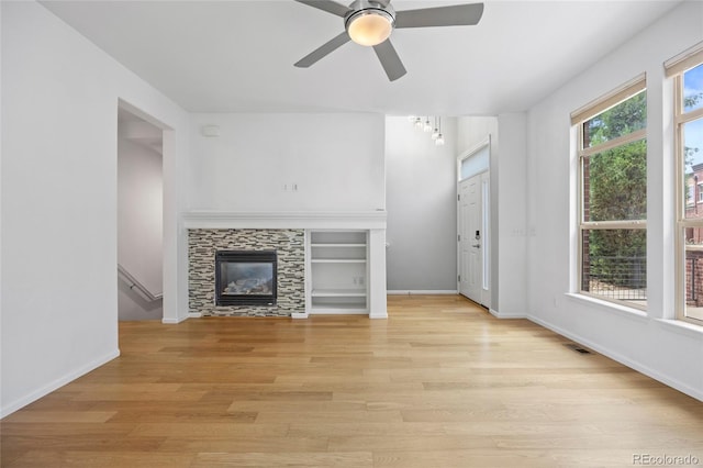 8987 E Otero Pl, Centennial, CO 80112 - unfurnished living room featuring light wood finished floors, ceiling fan, and a tile fireplace