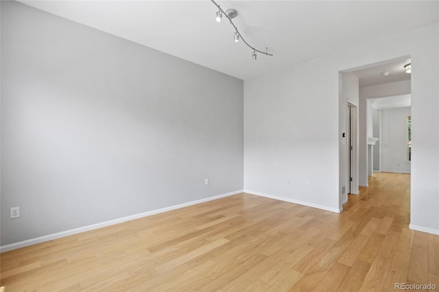 8987 E Otero Pl, Centennial, CO 80112 - empty room with light wood-style flooring and rail lighting