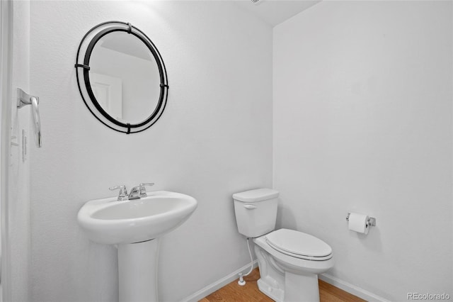 8987 E Otero Pl, Centennial, CO 80112 - half bath featuring wood finished floors and toilet