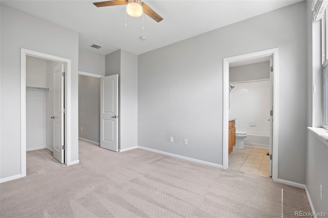 8987 E Otero Pl, Centennial, CO 80112 - unfurnished bedroom with light carpet, a spacious closet, connected bathroom, and ceiling fan