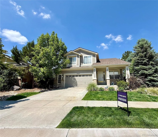 16063 E 106th Ct, Commerce City, CO 80022 - view of front of property with an attached garage, driveway, a front yard, and a porch