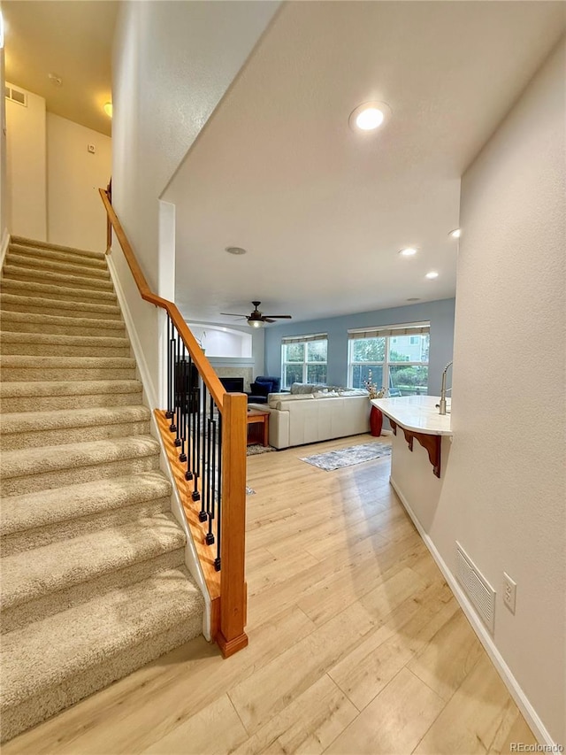16063 E 106th Ct, Commerce City, CO 80022 - stairs with ceiling fan, wood finished floors, recessed lighting, and baseboards