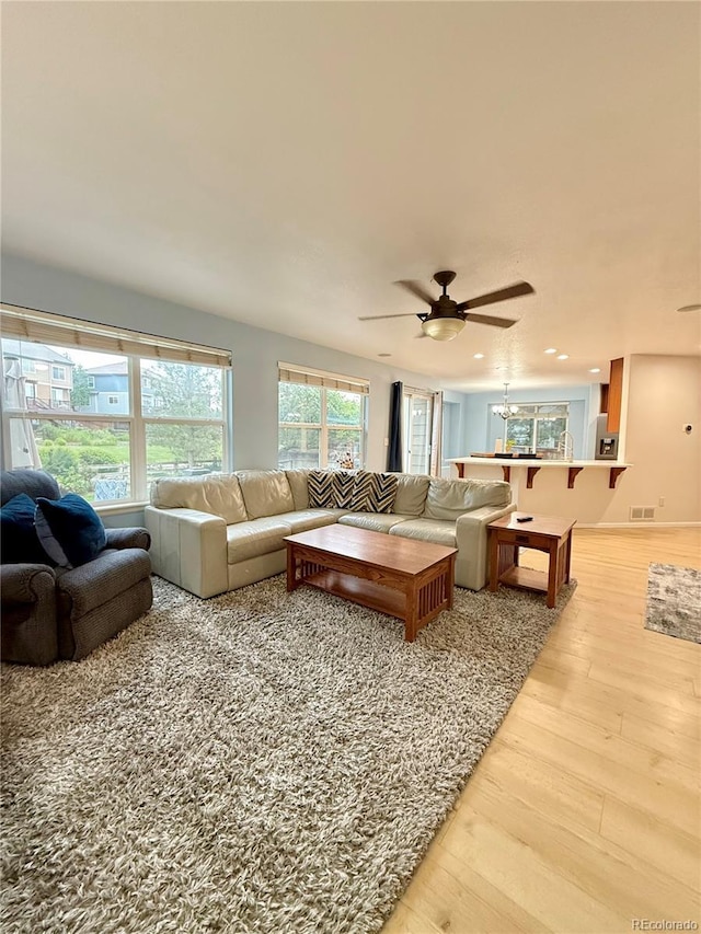 16063 E 106th Ct, Commerce City, CO 80022 - living area featuring light wood-type flooring, ceiling fan, recessed lighting, and a chandelier