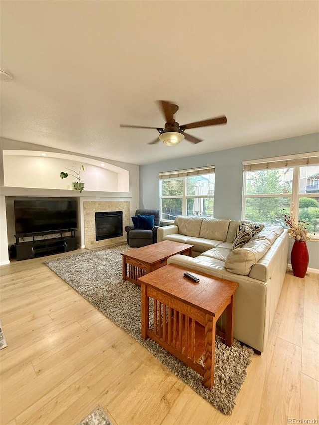 16063 E 106th Ct, Commerce City, CO 80022 - living room with a glass covered fireplace, a ceiling fan, and wood finished floors