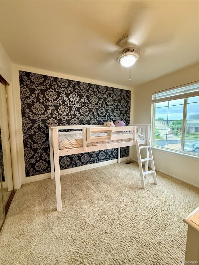16063 E 106th Ct, Commerce City, CO 80022 - bedroom with carpet, wallpapered walls, ceiling fan, and baseboards