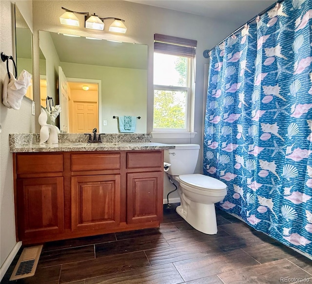 16063 E 106th Ct, Commerce City, CO 80022 - bathroom with toilet, wood tiled floors, and vanity