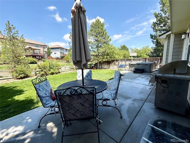 16063 E 106th Ct, Commerce City, CO 80022 - view of patio / terrace with a hot tub, outdoor dining area, and a residential view