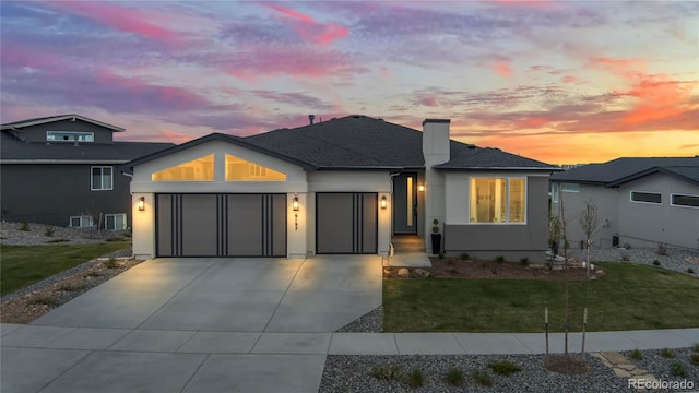 view of front of property featuring a yard and a garage