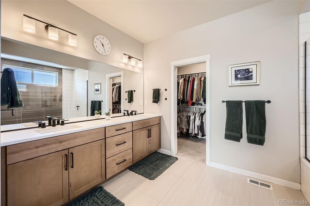 bathroom with tile patterned flooring, vanity, and an enclosed shower