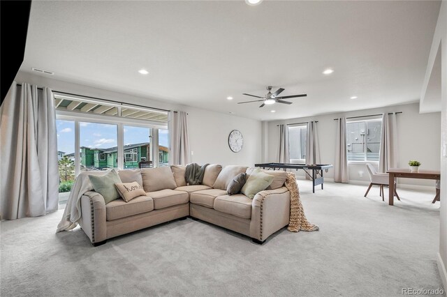 carpeted living room featuring ceiling fan