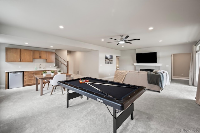 playroom featuring light colored carpet, wet bar, ceiling fan, and billiards