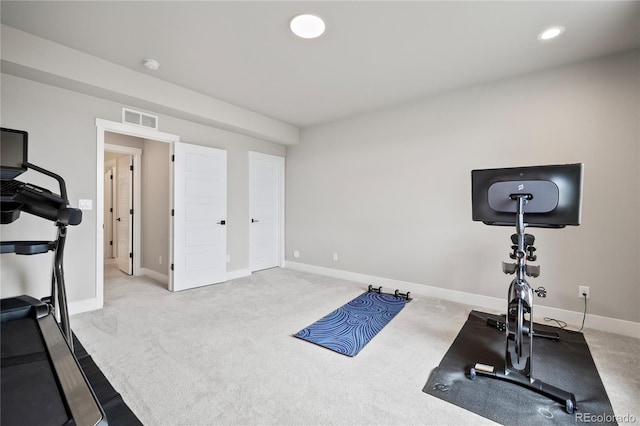 exercise room with light colored carpet