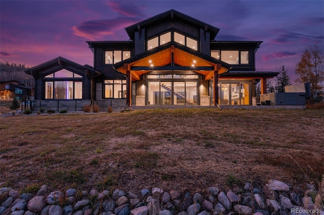 view of back house at dusk