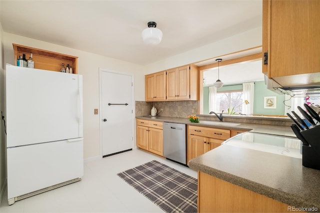 kitchen featuring a sink, stainless steel dishwasher, freestanding refrigerator, light brown cabinetry, and pendant lighting