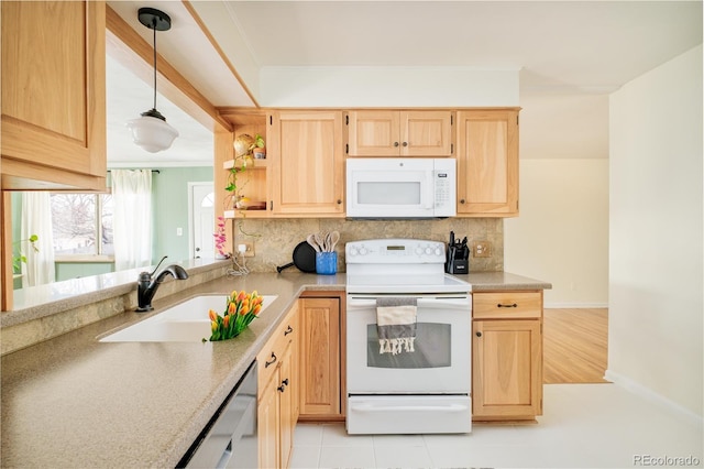 kitchen with light brown cabinets, white appliances, a sink, light countertops, and pendant lighting