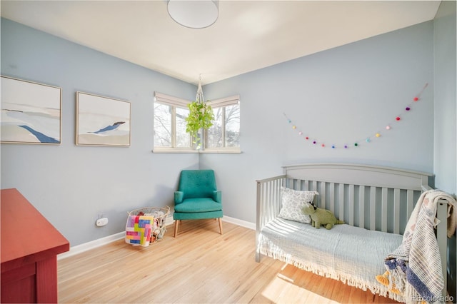 bedroom with wood finished floors and baseboards