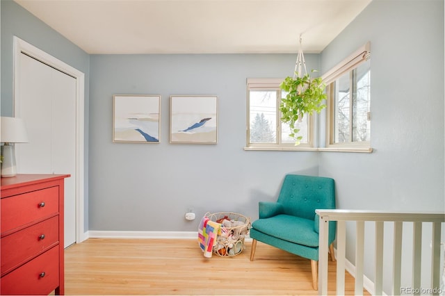 bedroom featuring light wood-style floors and baseboards