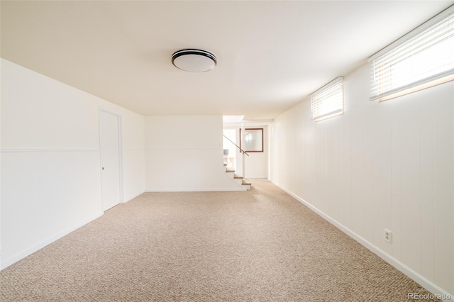 basement featuring stairway and carpet flooring