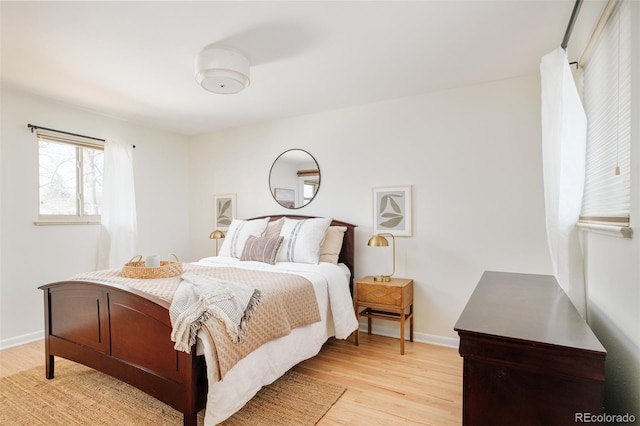 bedroom with baseboards and light wood finished floors