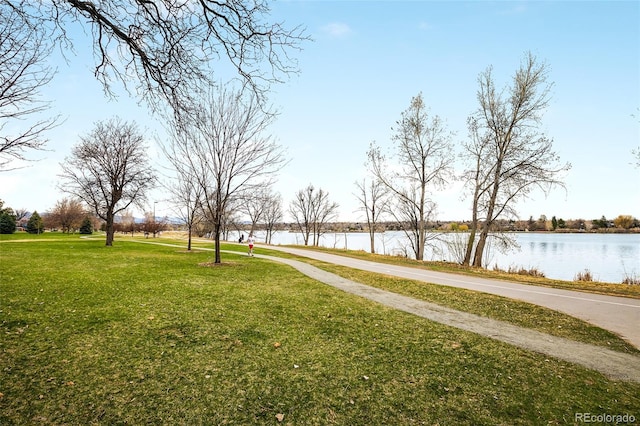 surrounding community featuring a yard and a water view