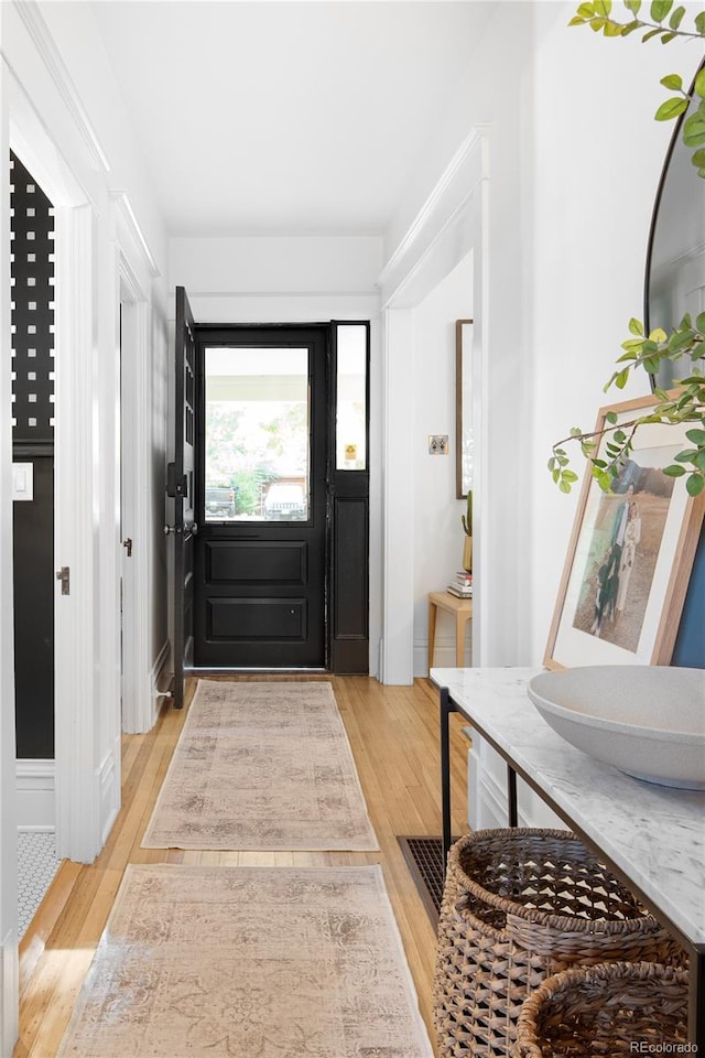 foyer with light wood-style floors