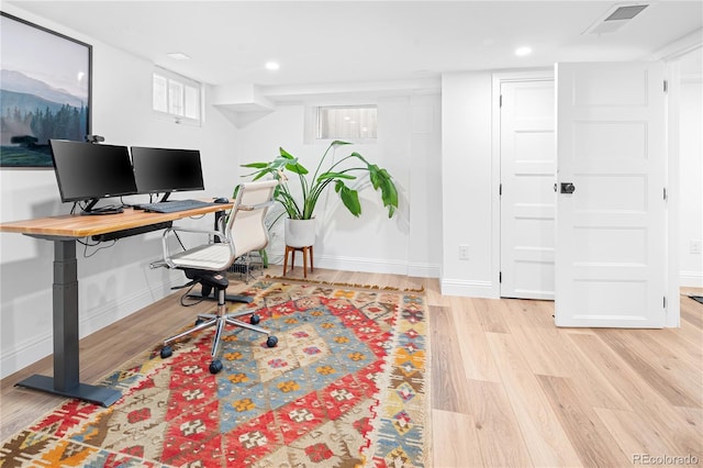 office area with light wood-style flooring, visible vents, baseboards, and recessed lighting