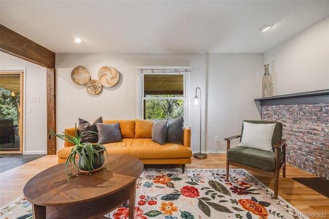 living room with wood finished floors, baseboards, and recessed lighting