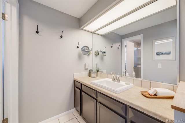 bathroom featuring tile patterned floors, vanity, and baseboards