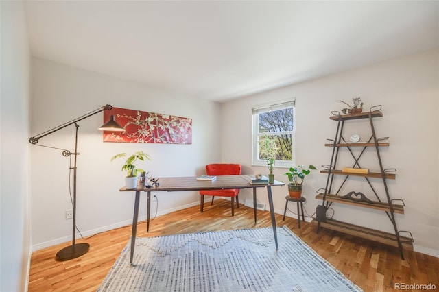 home office featuring wood finished floors and baseboards