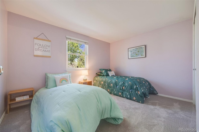 bedroom featuring carpet flooring and baseboards