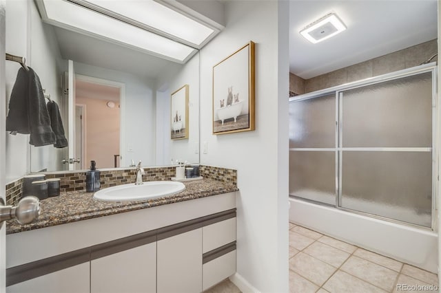 bathroom featuring vanity, backsplash, tile patterned floors, and enclosed tub / shower combo