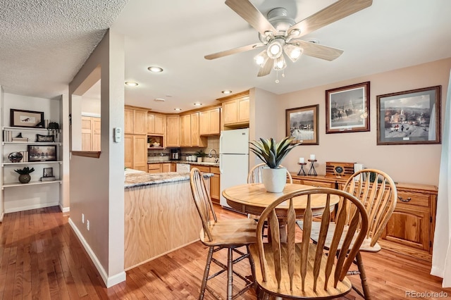 dining space with recessed lighting, light wood-type flooring, baseboards, and ceiling fan