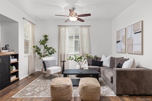 living room with a wealth of natural light, ceiling fan, and dark hardwood / wood-style floors