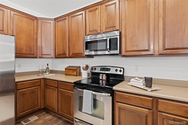 kitchen with dark hardwood / wood-style flooring and stainless steel appliances