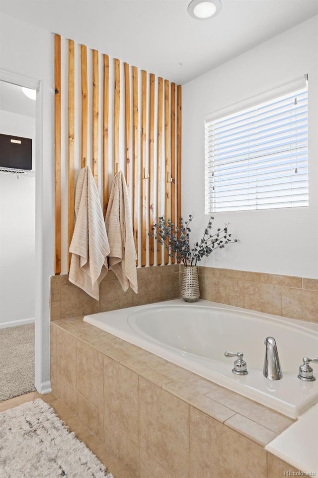 bathroom featuring tiled bath