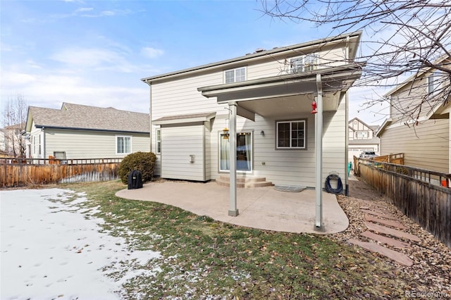 back of property with a patio