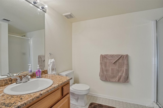 bathroom with vanity, toilet, and walk in shower